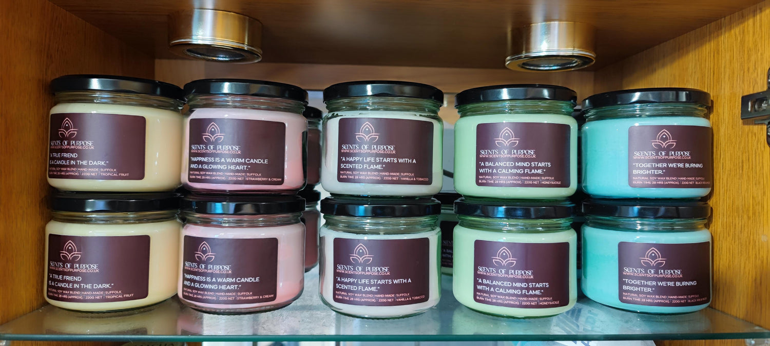 A two tied stacked on a shelf selection of scents of purpose candles